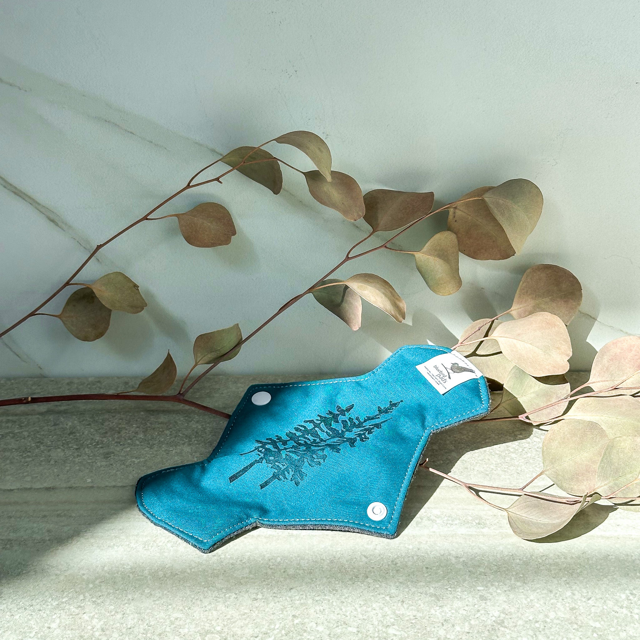 A Bluebird reusable menstrual pad in short 7.5" size for light to regular day use