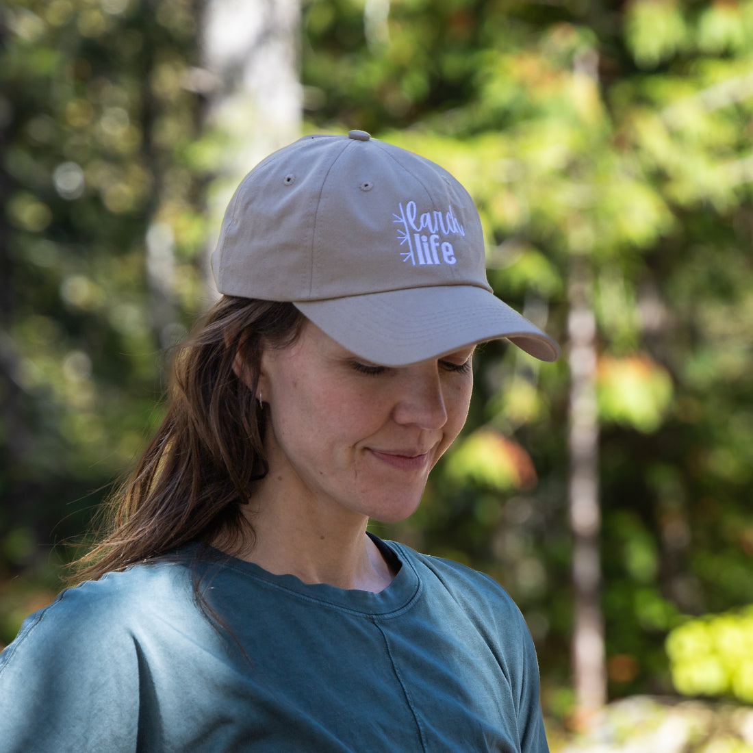 A person wears a light brown recycled cotton &