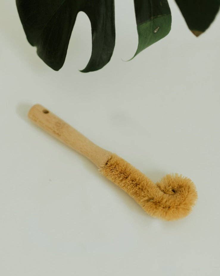 A natural bamboo bottle cleaning brush