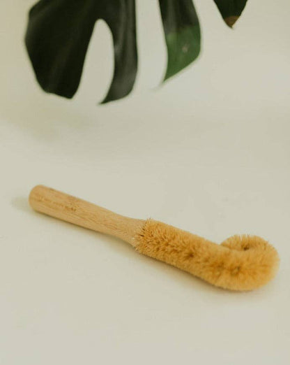 A natural bamboo bottle cleaning brush