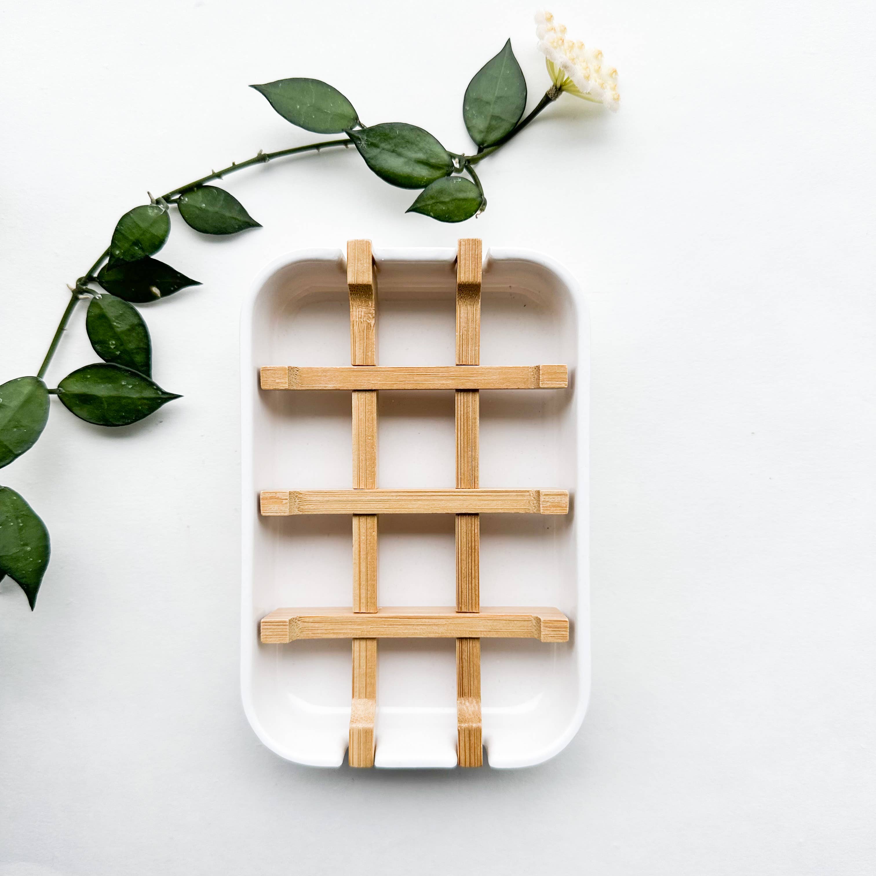 A white biodegradable soap dish made of natural bamboo and corn starch