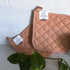 Two quilted cotton potholders in "nectar" pink colour