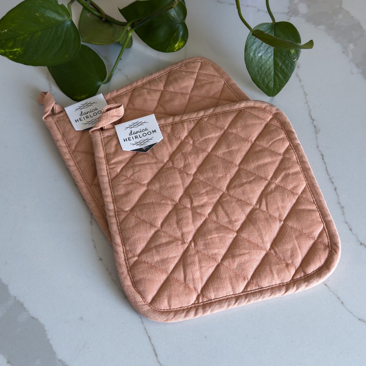 Two quilted cotton potholders in &quot;nectar&quot; pink colour