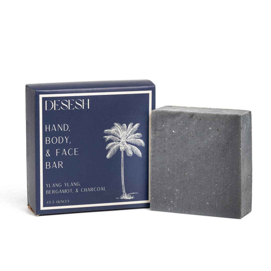 A bar of Desesh natural bar soap in ylang ylang, bergamot, and charcoal variety