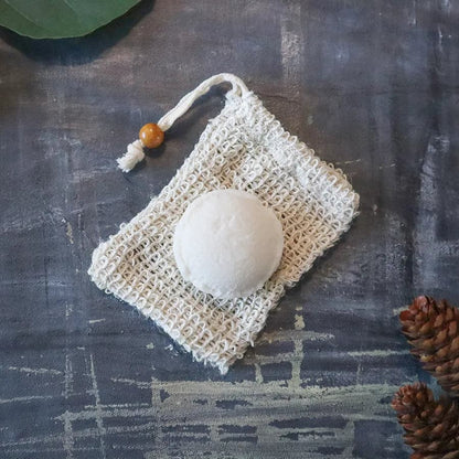 Eco-friendly hydrating shampoo bar on top of a sisal bag