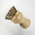 A natural bamboo dish brush with replaceable head