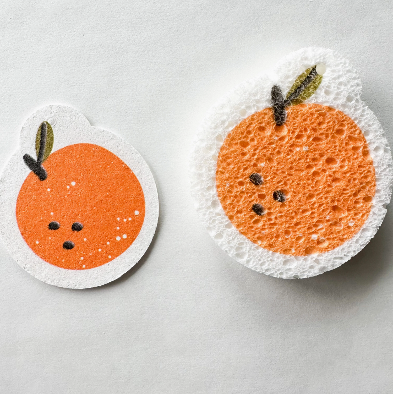 A natural cellulose pop-up sponge with an orange graphic