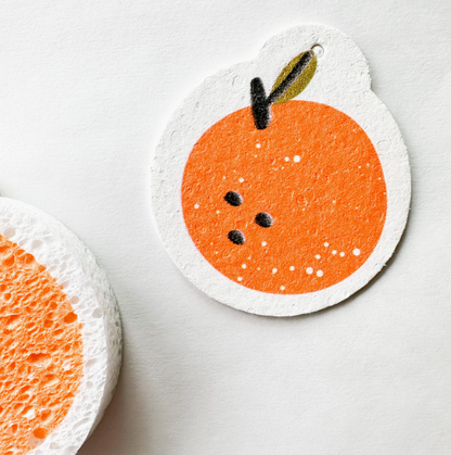 A natural cellulose pop-up sponge with an orange graphic