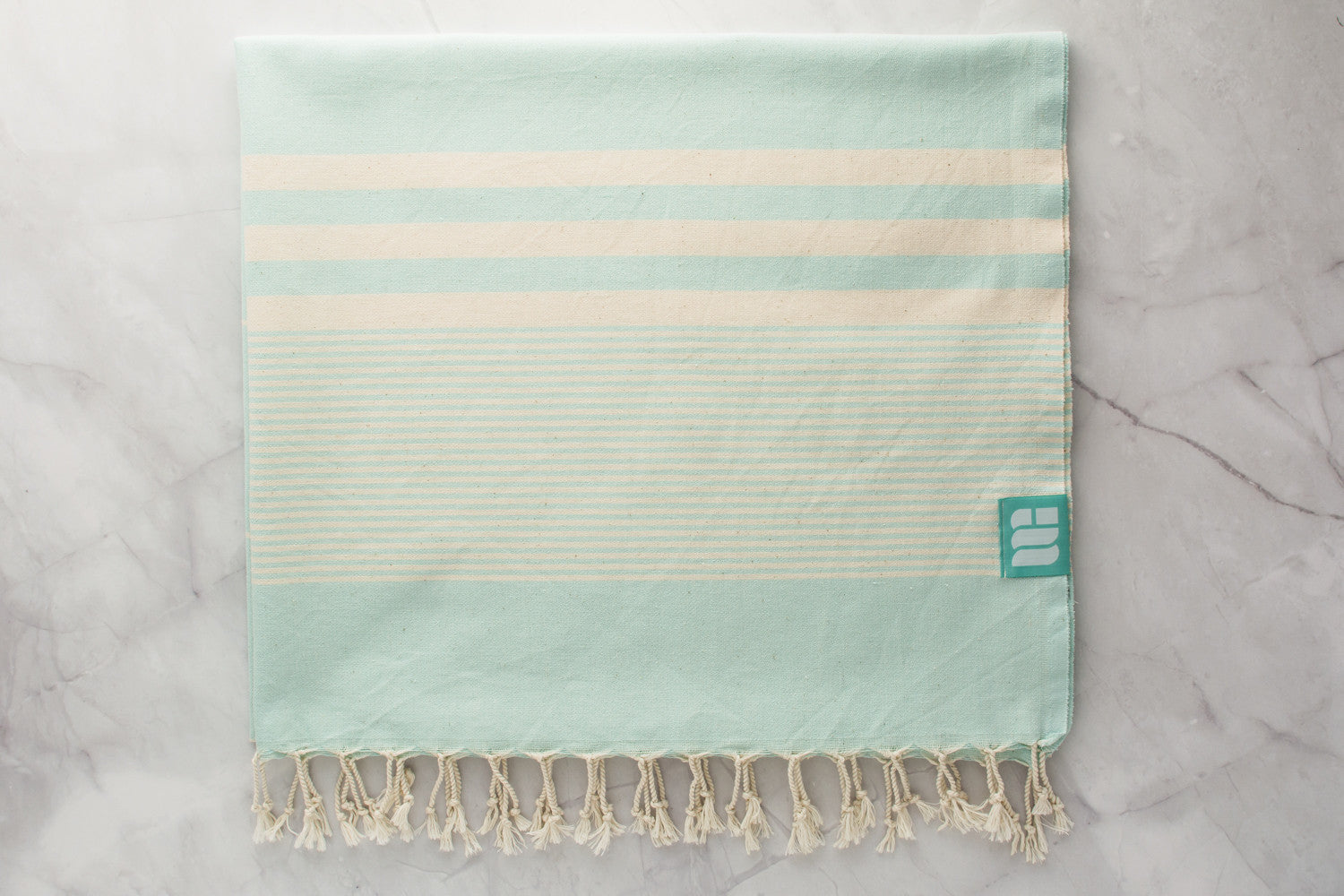 An aqua lightweight Turkish bath towel