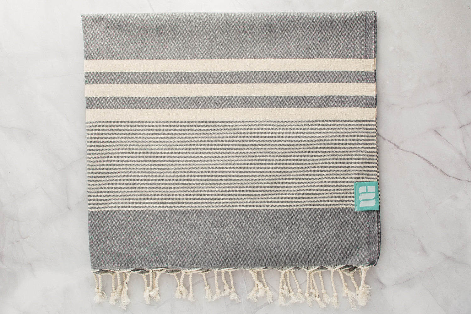 A charcoal grey lightweight Turkish bath towel