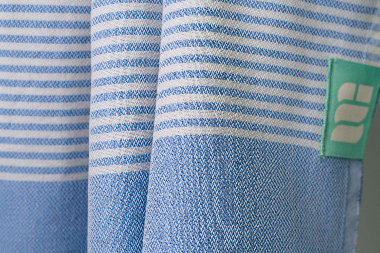 A close up of a denim blue lightweight Turkish bath towel showing texture