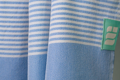 A close up of a denim blue lightweight Turkish bath towel showing texture