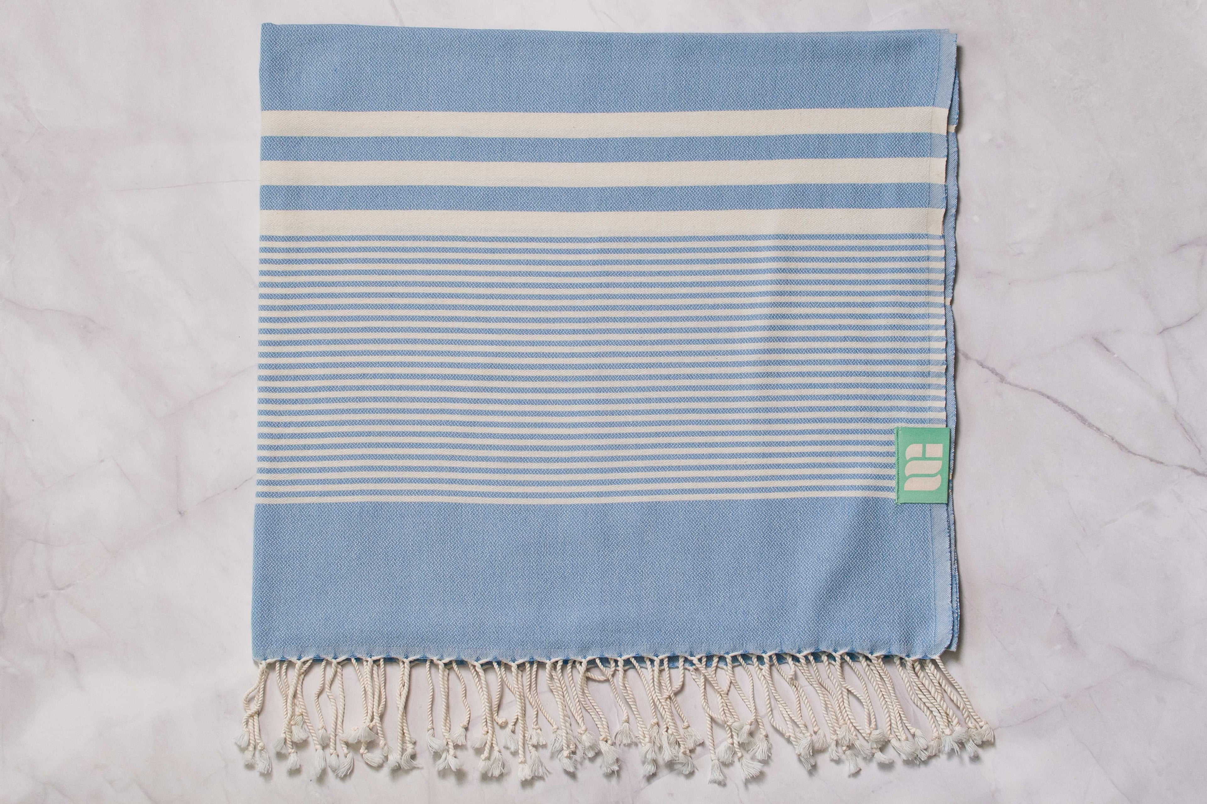 A denim blue lightweight Turkish bath towel