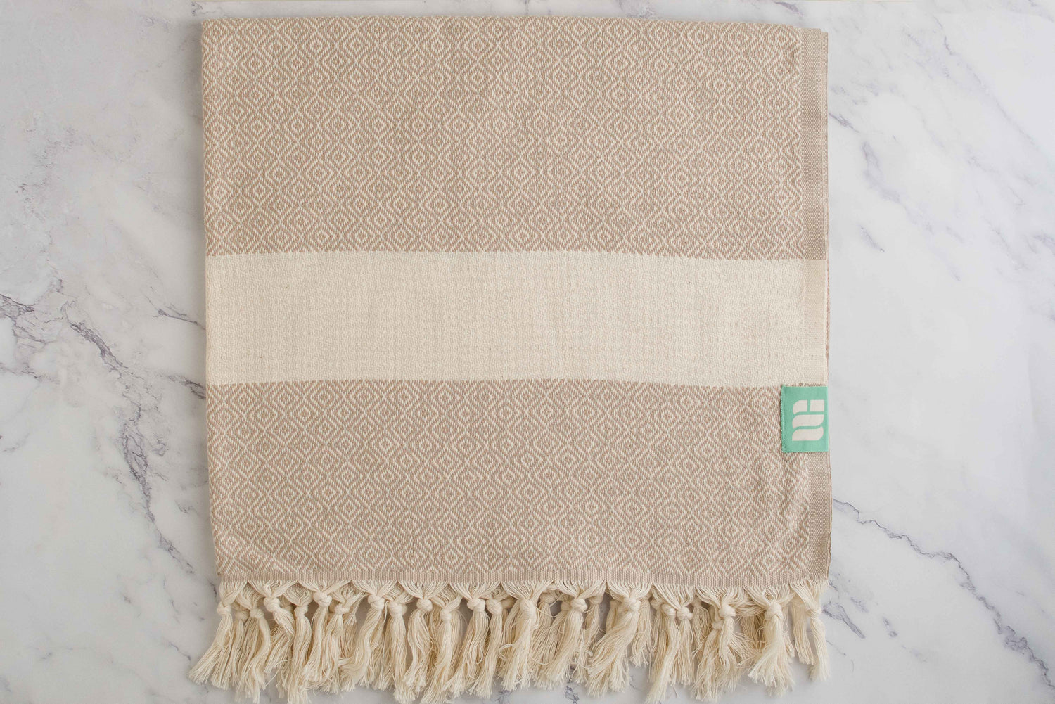 A beige heavy weight geometric patterned Turkish bath towel