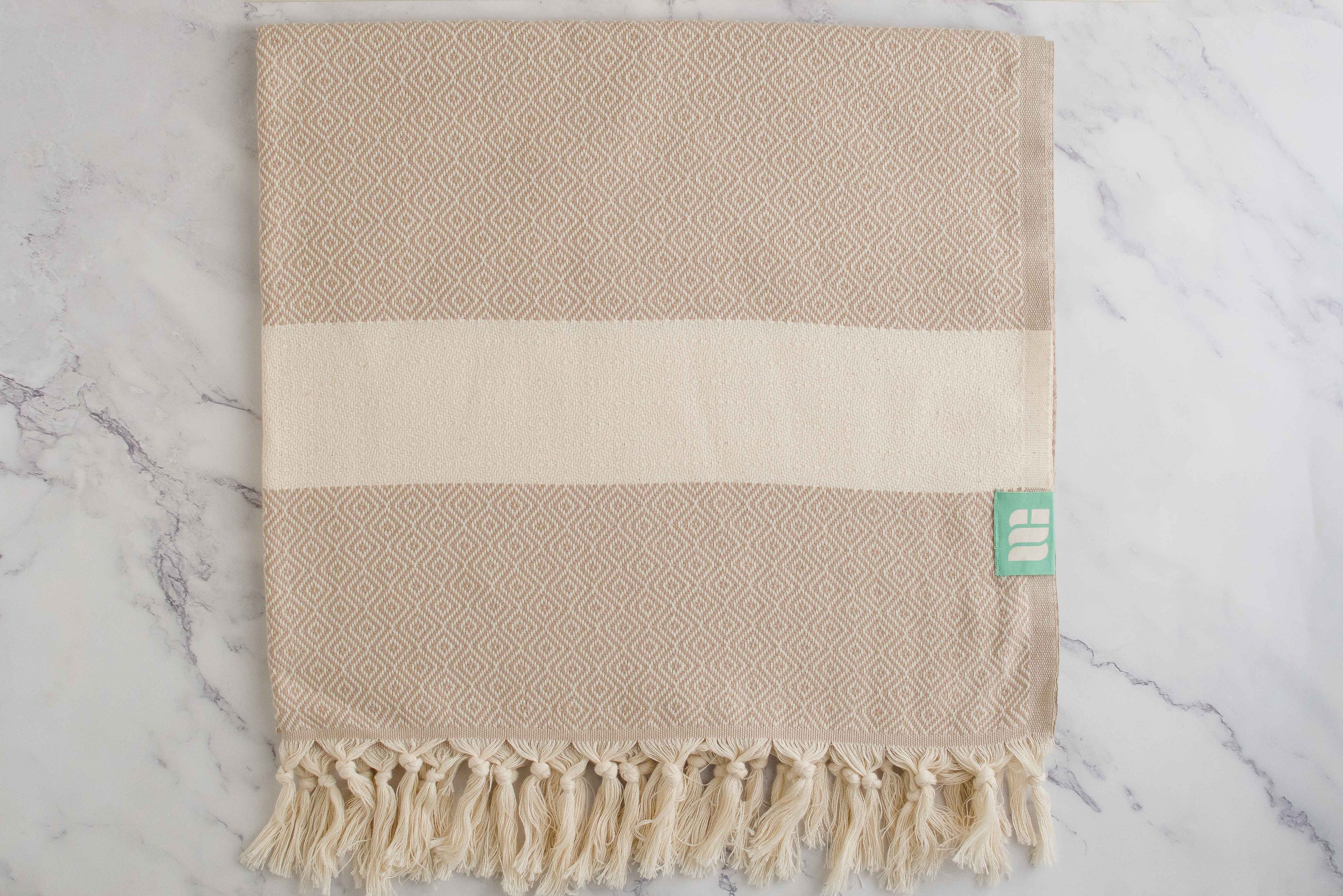 A beige heavy weight geometric patterned Turkish bath towel