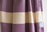 A close up of a purple heavy weight geometric patterned Turkish bath towel showing texture