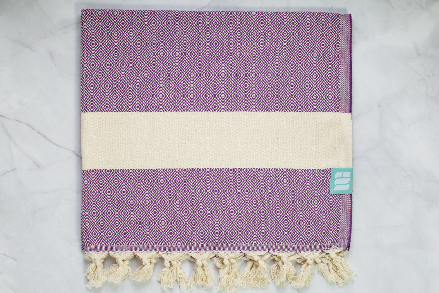 A purple heavy weight geometric patterned Turkish bath towel