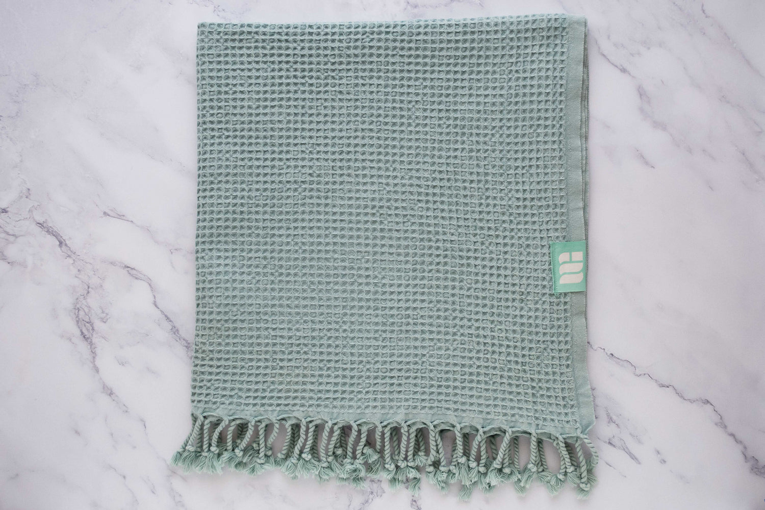 A waffle texture natural cotton Turkish bath towel in aqua