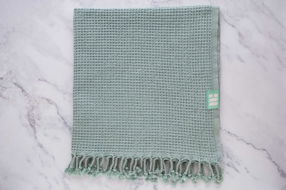 A waffle texture natural cotton Turkish bath towel in aqua