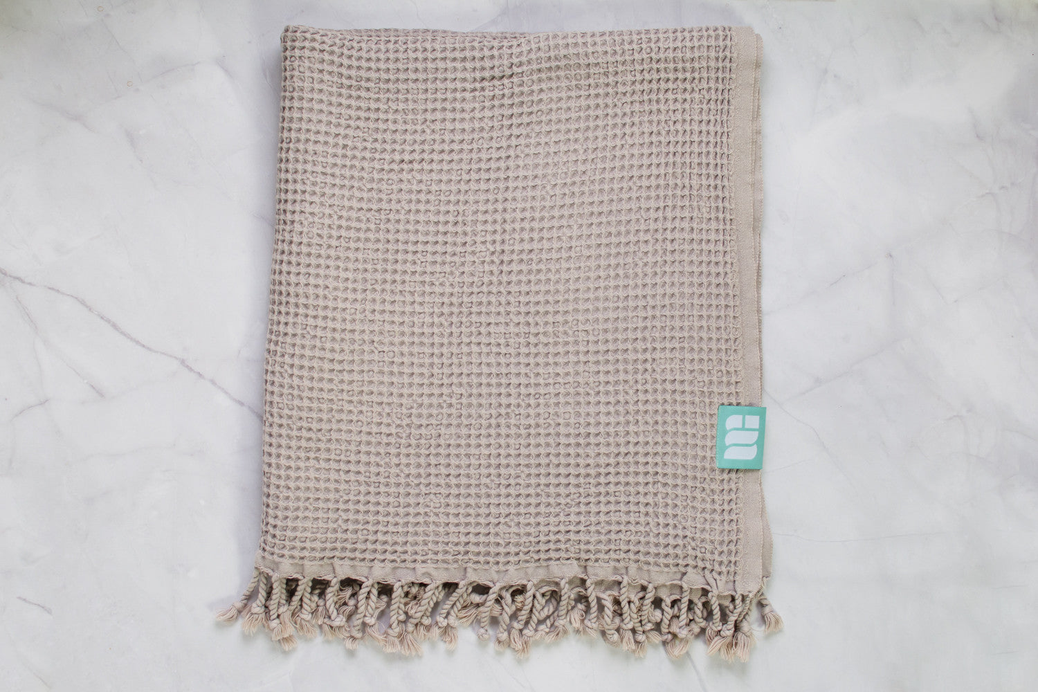 A waffle texture natural cotton Turkish bath towel in beige