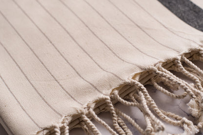 A close up of a natural cotton Turkish hand towel showing detail and texture