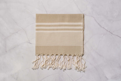 A beige lightweight Turkish hand towel