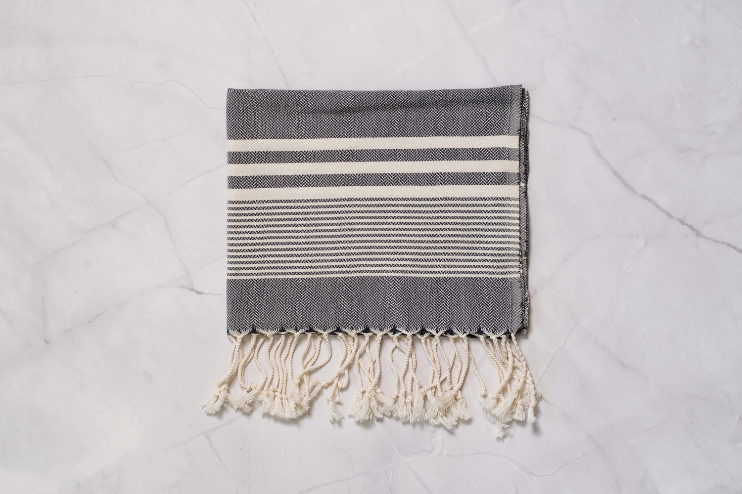 A charcoal grey lightweight Turkish hand towel