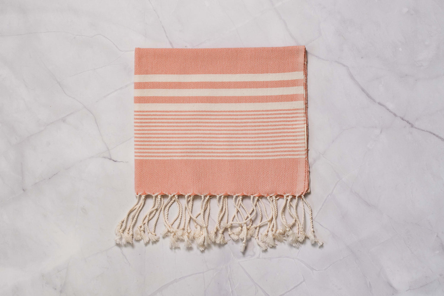 A salmon lightweight Turkish hand towel