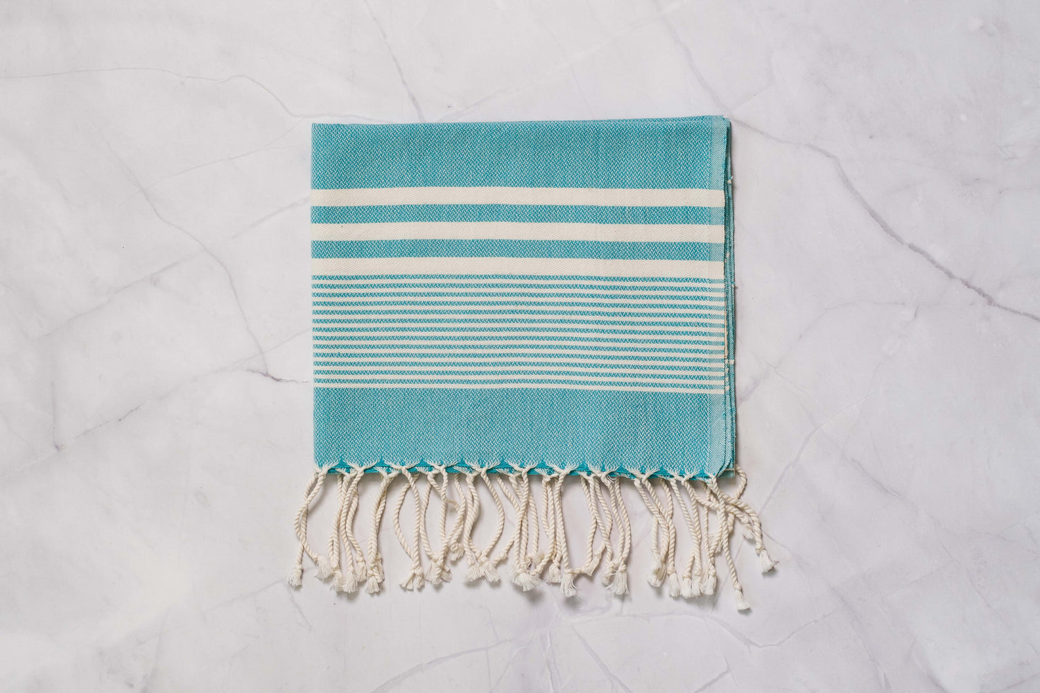 A teal lightweight Turkish hand towel