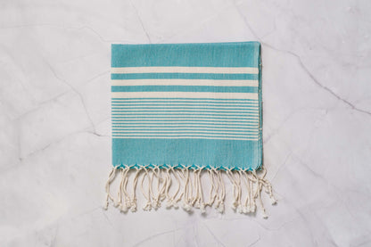 A teal lightweight Turkish hand towel