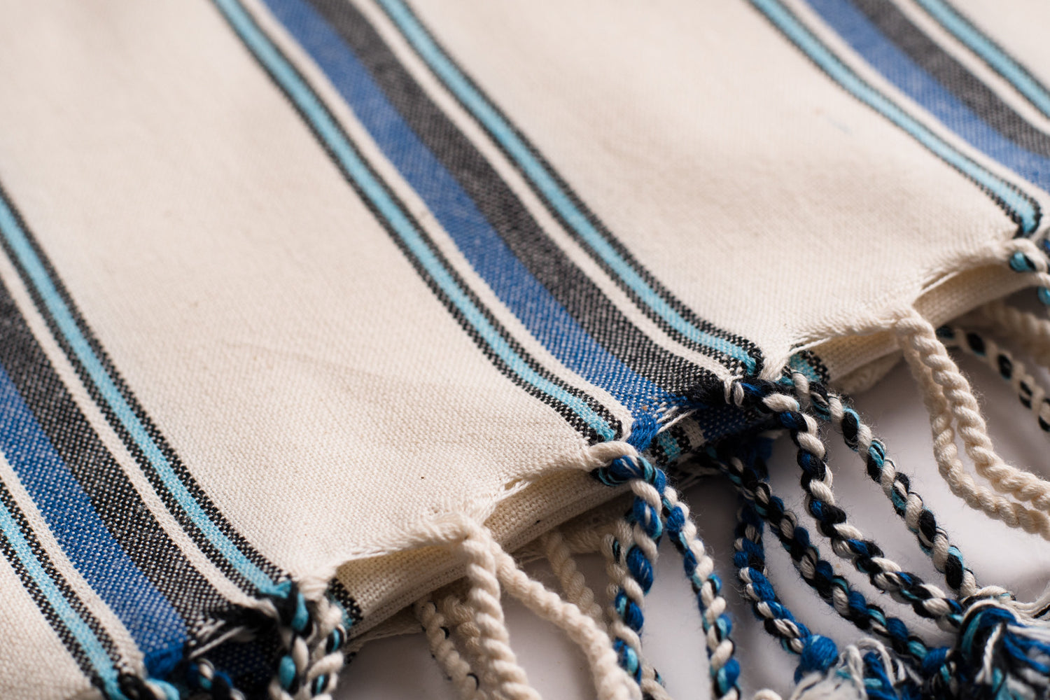 A close up of a white and green natural cotton Turkish hand towel showing detail