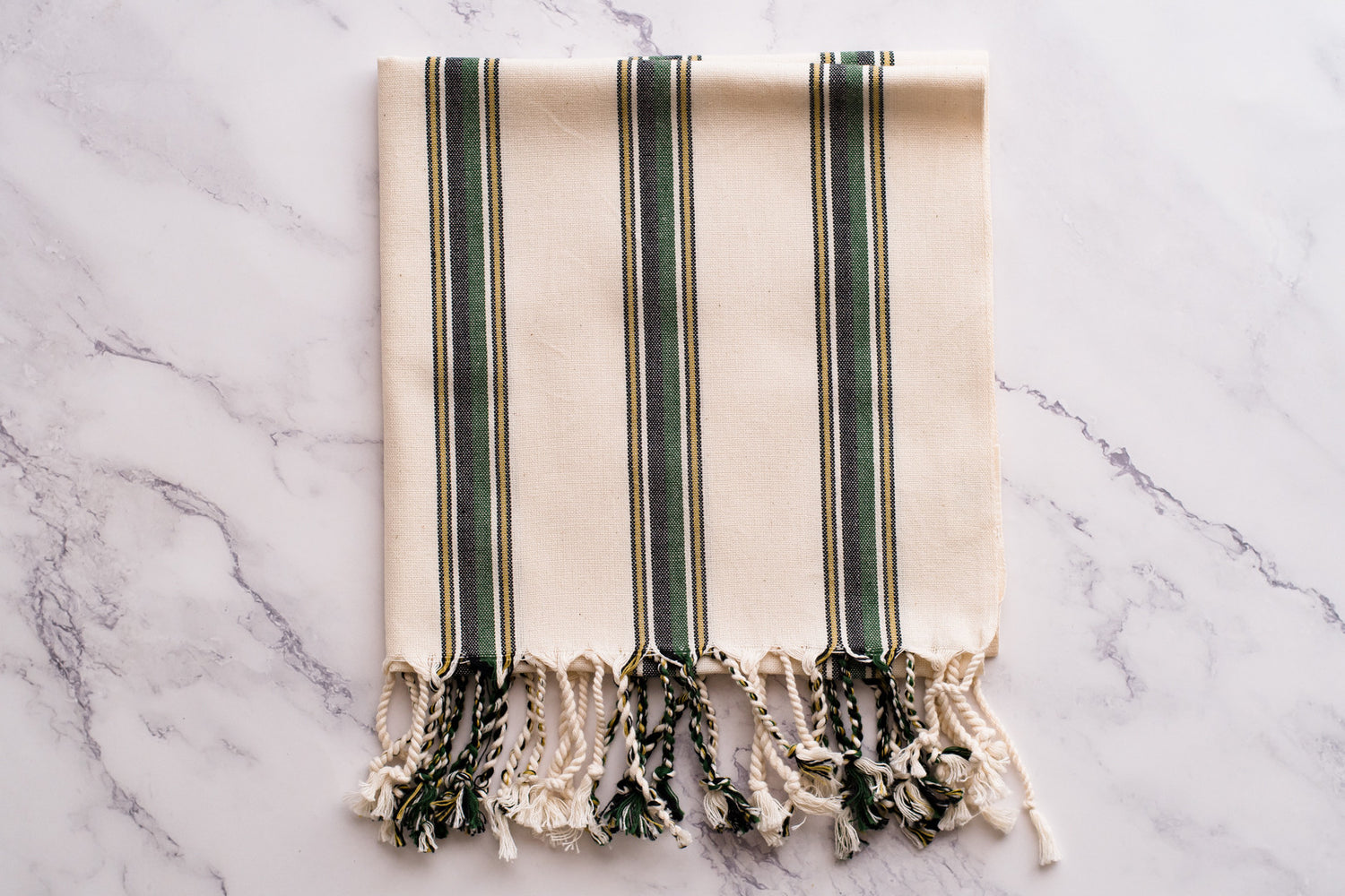 A white and green natural cotton Turkish hand towel