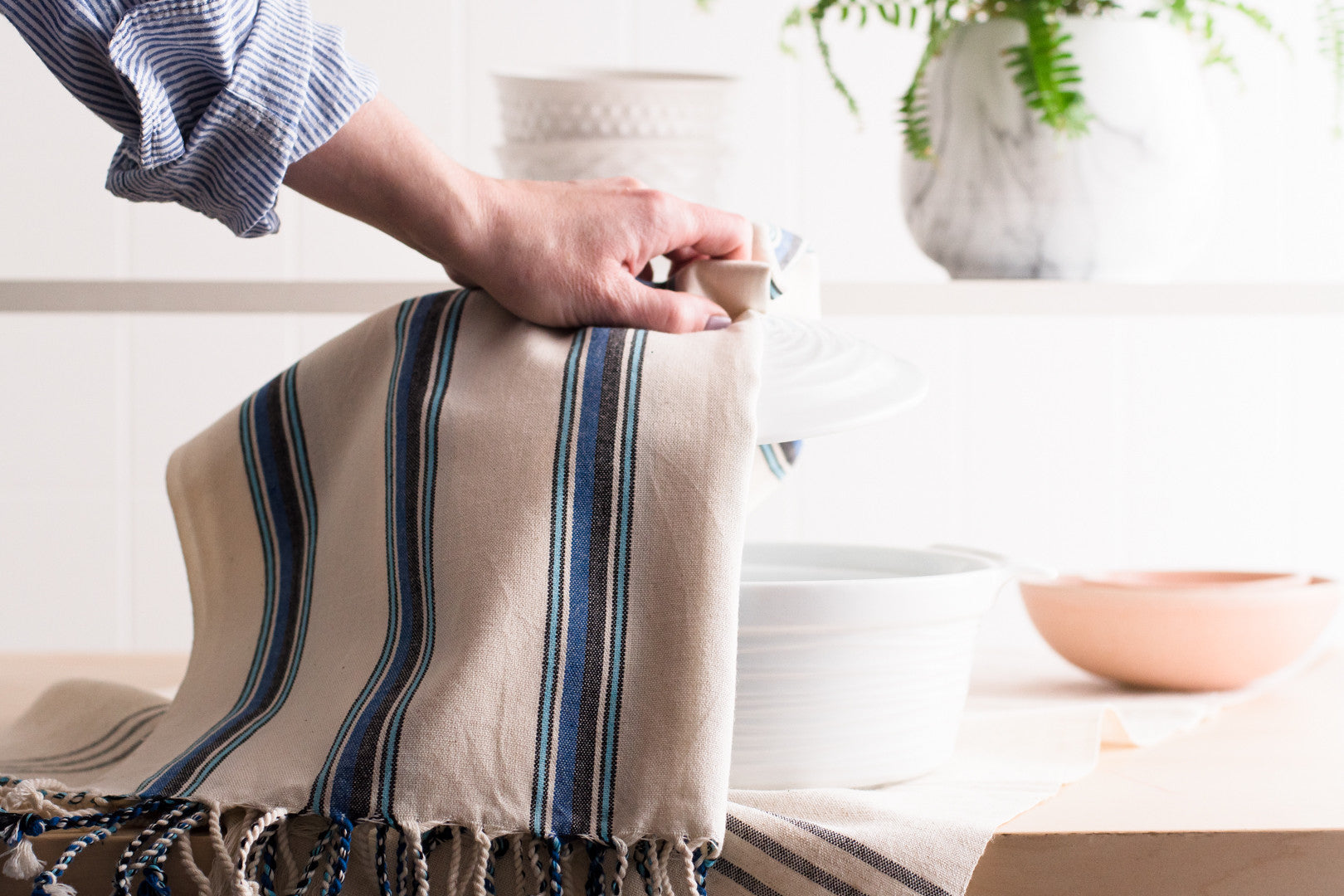 A natural cotton Turkish hand towel being used in a kitchen