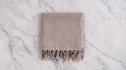 A waffle texture natural cotton Turkish hand towel in beige