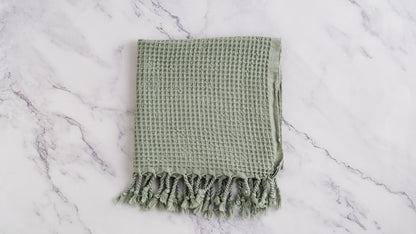 A waffle texture natural cotton Turkish hand towel in green