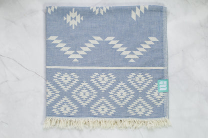 A medium weight Turkish bath towel in denim blue with geometric pattern