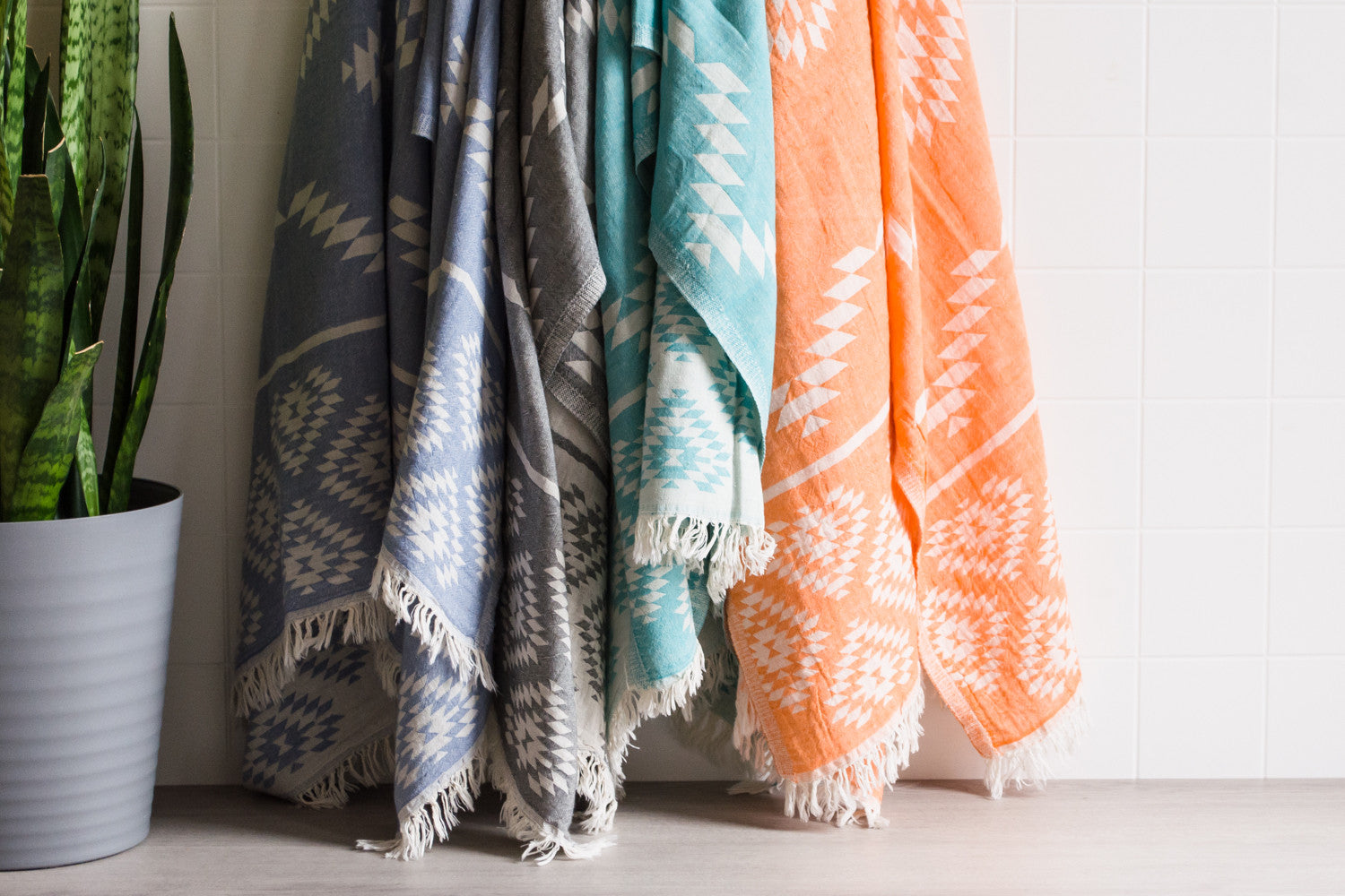 Three medium weight Turkish bath towels in a variety of colours hanging up