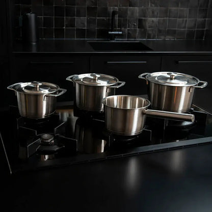 COMBEKK stainless steel pot set on a gas range