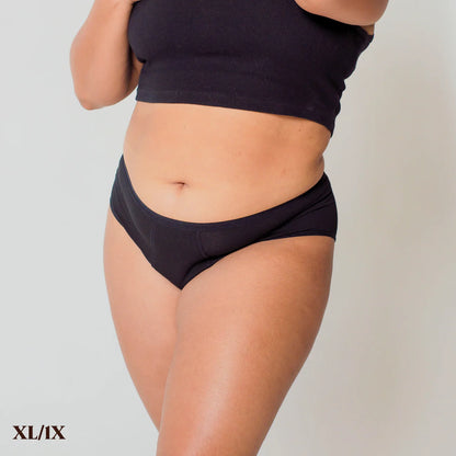 A person wearing REVOL bikini briefs in size XL/1X