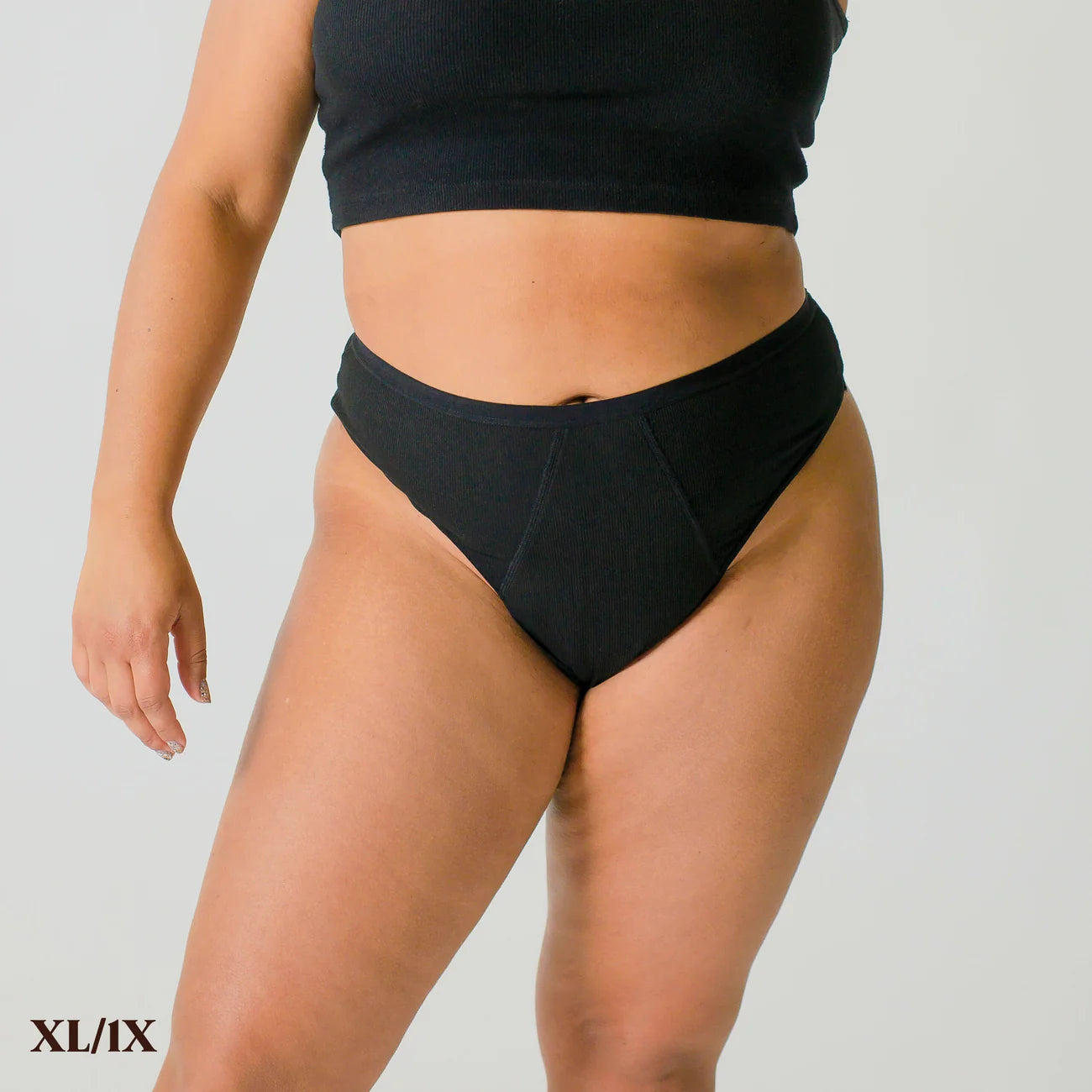 A person wears size XL/1X REVOL thong underwear