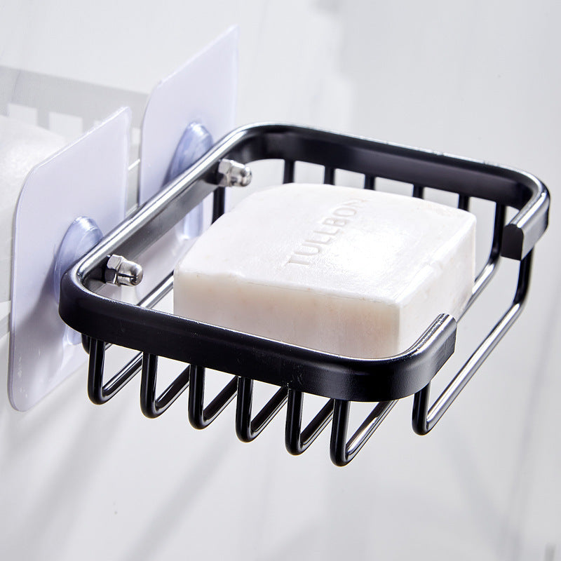 A bar of soap sits in a black suction cup shower tray