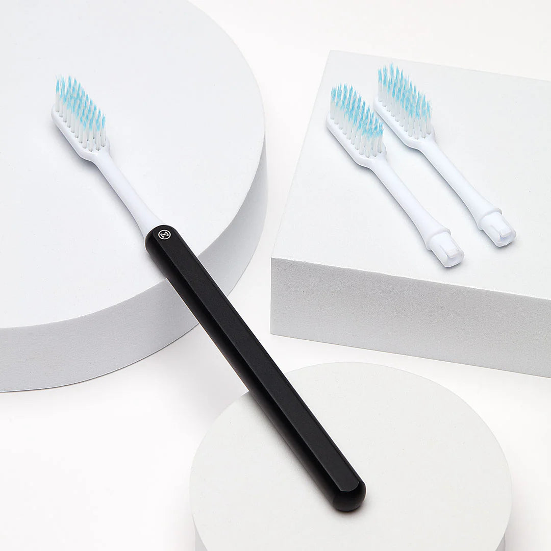 A sustainable Nada toothbrush with black anodized handle