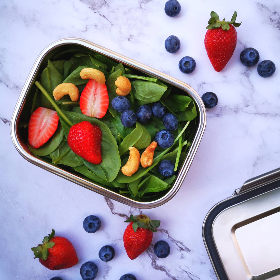 A medium stainless steel bento box holding a salad