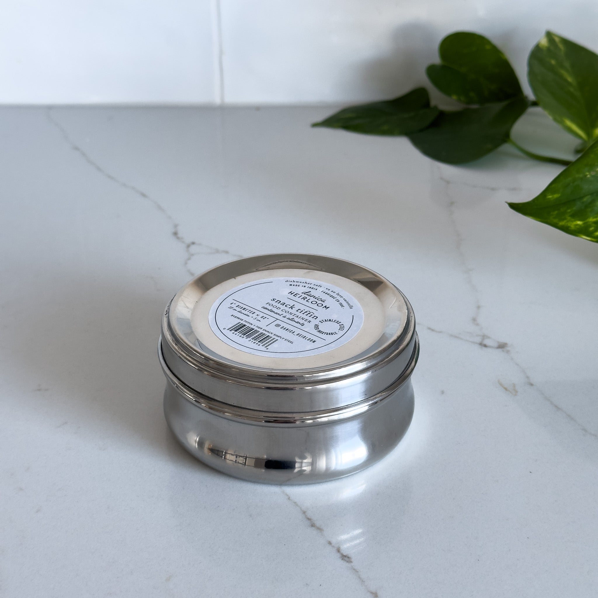 A small stainless steel snack container