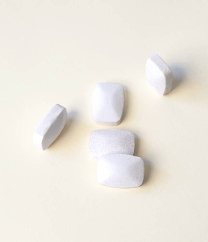 A close-up of five TANIT dish detergent tabs